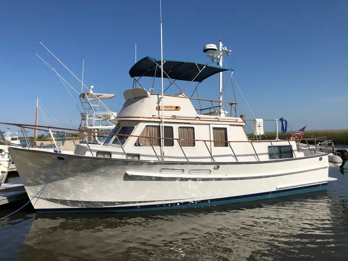 Monarch Yacht Photos Pics 1997 Monk 36 boat docked in calm waters under clear blue sky.