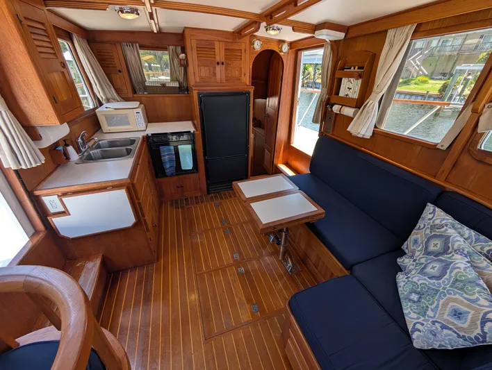 Monarch Yacht Photos Pics Cozy 1997 Monk 36 boat interior with wood finish, kitchenette, and seating area.
