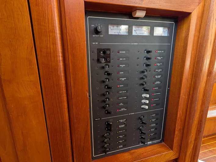 Monarch Yacht Photos Pics Electrical panel on a 1997 Monk 36 boat, featuring switches and meters in a wooden frame.