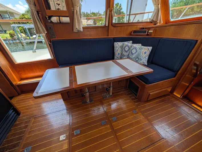 Monarch Yacht Photos Pics Interior of a 1997 Monk 36 boat with wooden flooring and a cozy seating area.