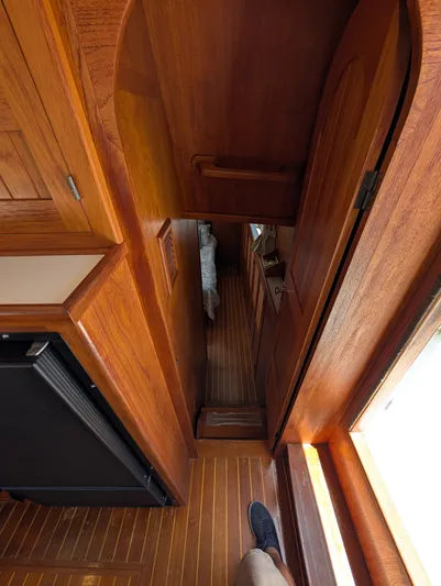 Monarch Yacht Photos Pics Wooden interior of a 1997 Monk 36 boat, featuring a narrow hallway and door.