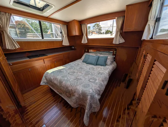 Monarch Yacht Photos Pics Cozy cabin interior of 1997 Monk 36 boat with bed and wooden furnishings.