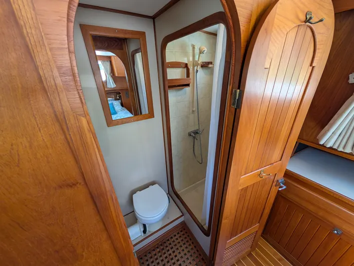 Monarch Yacht Photos Pics Wood-paneled bathroom in 1997 Monk 36 boat, featuring shower and toilet.