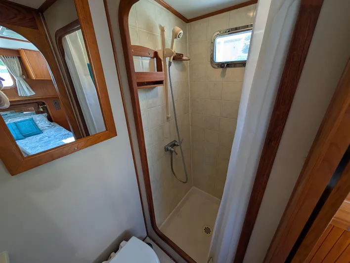 Monarch Yacht Photos Pics Compact shower in 1997 Monk 36 boat with wooden accents and small window.