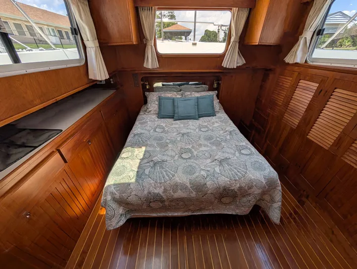 Monarch Yacht Photos Pics Cozy cabin interior of 1997 Monk 36 boat with bed and wooden furnishings.