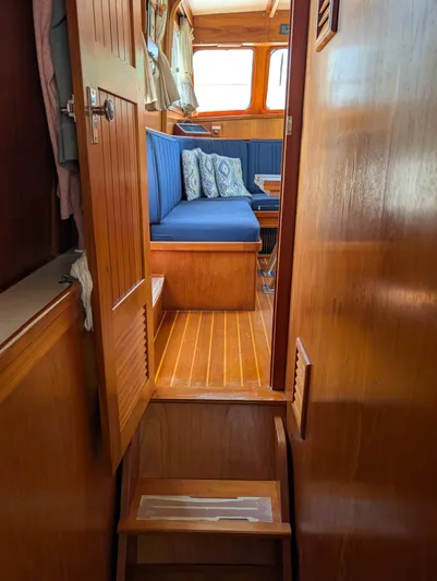 Monarch Yacht Photos Pics Interior of a 1997 Monk 36 boat with wooden finish and blue seating.