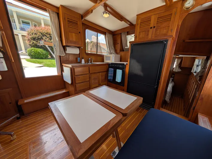 Monarch Yacht Photos Pics Interior of 1997 Monk 36 boat with wooden cabinetry and dining area.