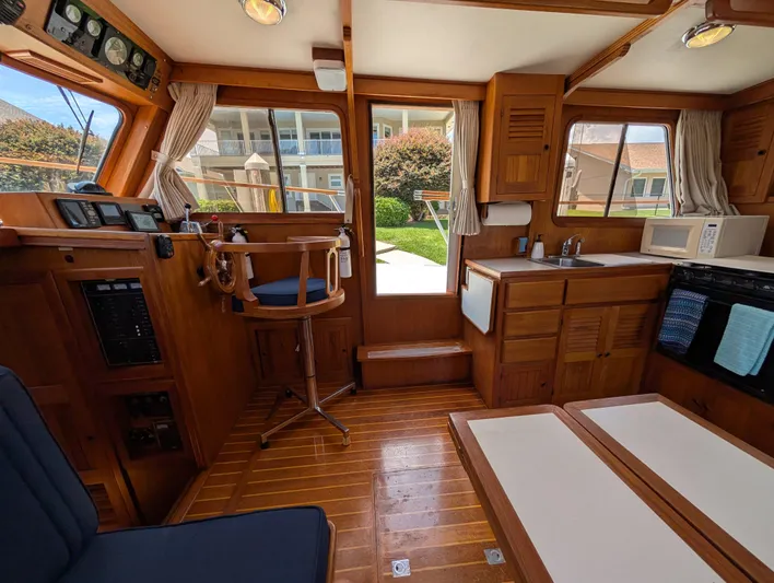 Monarch Yacht Photos Pics Interior of a 1997 Monk 36 boat, featuring wooden cabinetry and nautical decor.