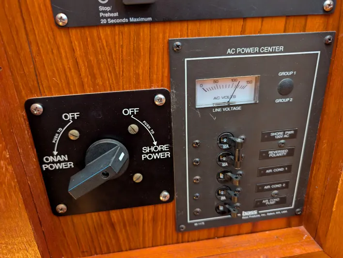 Monarch Yacht Photos Pics 1997 Monk 36 AC power center with Onan and shore power switches on wooden panel.