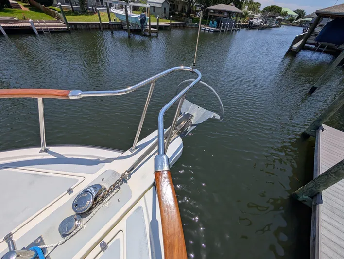 Monarch Yacht Photos Pics Bow of 1997 Monk 36 yacht docked in a serene marina setting.