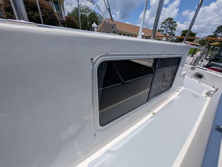 Monarch Yacht Photos Pics 1997 Monk 36 boat exterior with window, showcasing sleek design and clear skies.