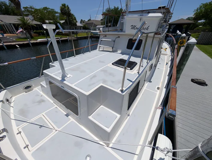 Monarch Yacht Photos Pics 1997 Monk 36 yacht docked, showcasing spacious deck and sleek design.