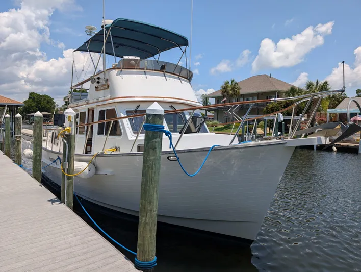Monarch Yacht Photos Pics 1997 Monk 36 yacht docked at marina under blue sky.