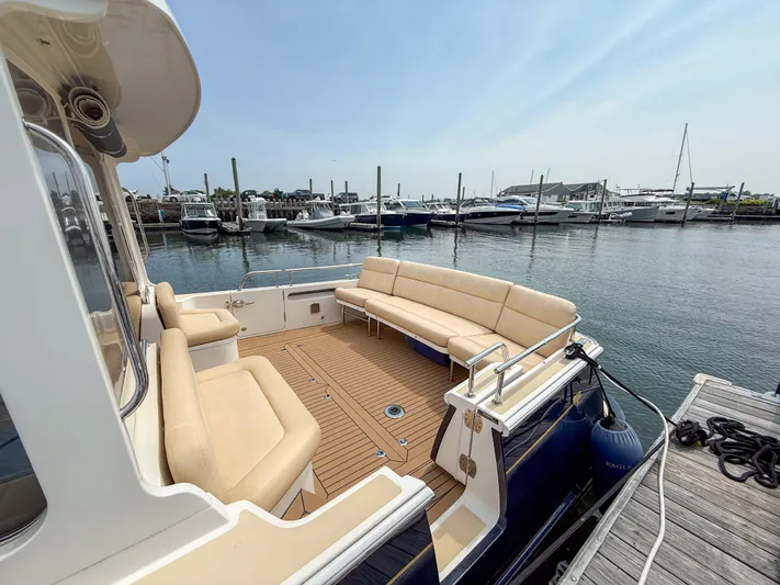 Eagle Wing Yacht Photos Pics 2017 MJM 40z Downeast yacht with spacious deck and seating at marina.
