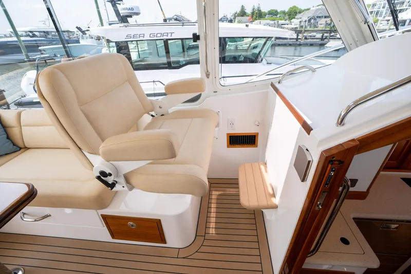 Eagle Wing Yacht Photos Pics Interior of 2017 MJM 40z Downeast yacht with beige seating and wooden accents.