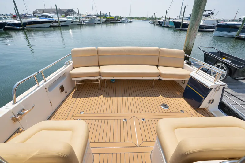 Eagle Wing Yacht Photos Pics 2017 MJM 40z Downeast boat with spacious deck and beige seating at marina.