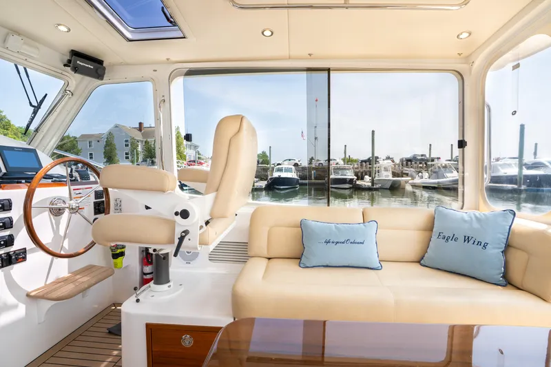Eagle Wing Yacht Photos Pics Interior of 2017 MJM 40z Downeast yacht with helm, seating, and marina view.