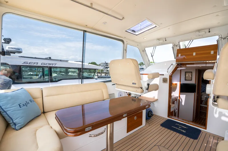 Eagle Wing Yacht Photos Pics Luxurious interior of 2017 MJM 40z Downeast yacht with elegant seating and wooden accents.