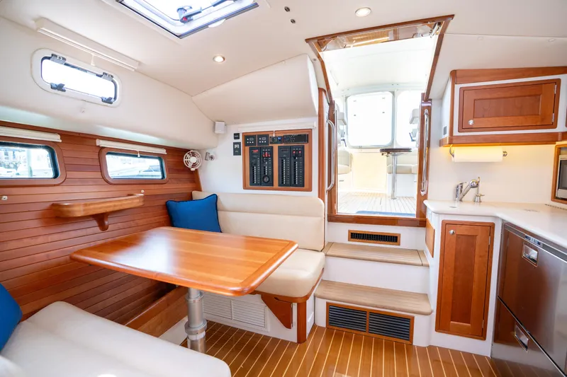 Eagle Wing Yacht Photos Pics Luxurious interior of 2017 MJM 40z Downeast yacht with wood finishes and seating area.