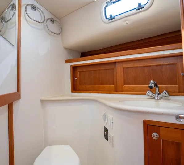 Eagle Wing Yacht Photos Pics 2017 MJM 40z Downeast yacht bathroom with wooden cabinets and modern fixtures.