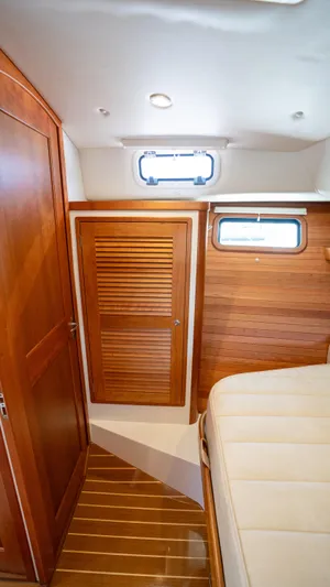 Eagle Wing Yacht Photos Pics 2017 MJM 40z Downeast cabin interior with wooden finishes and a small window.