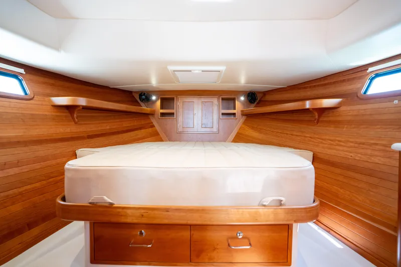 Eagle Wing Yacht Photos Pics 2017 MJM 40z Downeast cabin interior with wooden walls and bed.