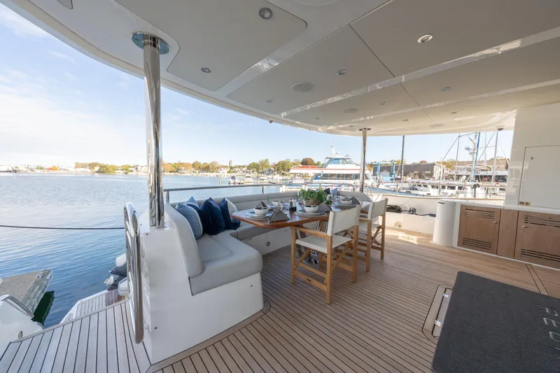Reunion Yacht Photos Pics Luxurious 2019 Sunseeker 95 Yacht deck with elegant dining area overlooking marina.