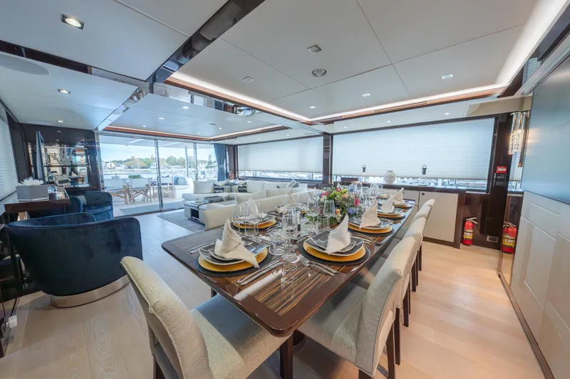 Reunion Yacht Photos Pics Luxurious interior of 2019 Sunseeker 95 Yacht with elegant dining setup and modern furnishings.