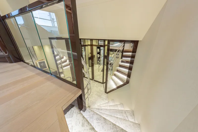 Reunion Yacht Photos Pics Luxurious interior staircase of 2019 Sunseeker 95 Yacht with elegant design.