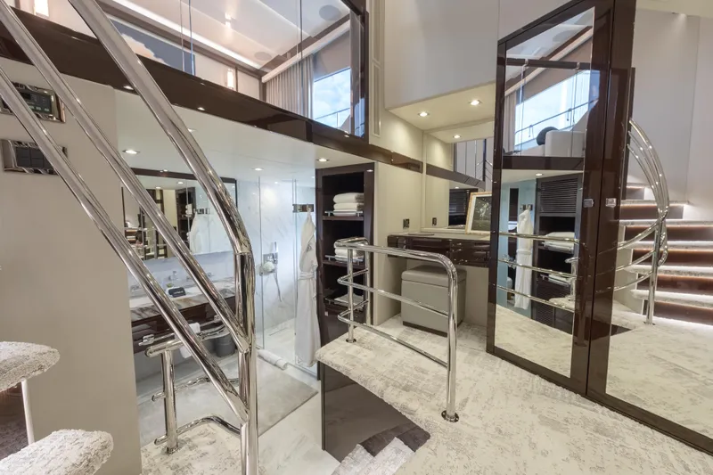 Reunion Yacht Photos Pics Luxurious interior of 2019 Sunseeker 95 Yacht with modern design and elegant staircase.