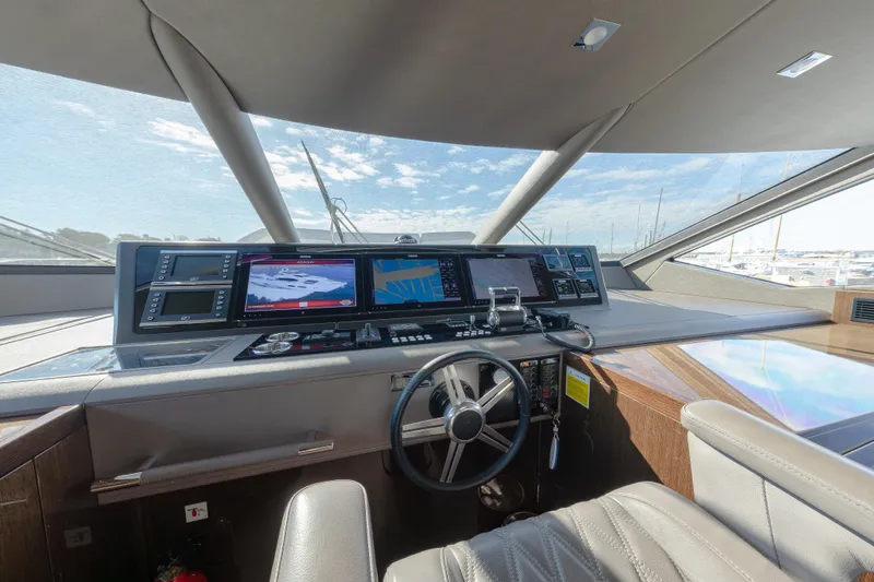 Reunion Yacht Photos Pics Helm of 2019 Sunseeker 95 Yacht with advanced navigation systems and luxurious interior.