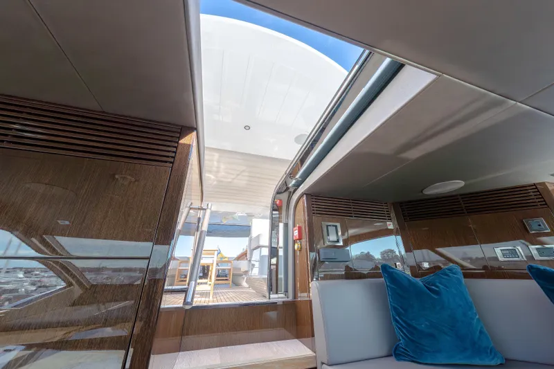 Reunion Yacht Photos Pics Luxurious interior of 2019 Sunseeker 95 Yacht with plush seating and open deck view.