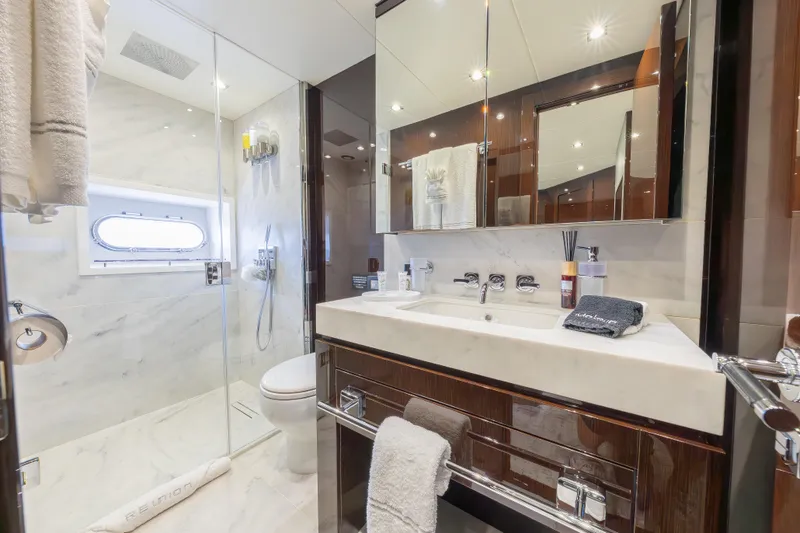 Reunion Yacht Photos Pics Luxurious bathroom on a 2019 Sunseeker 95 Yacht with elegant marble and modern fixtures.