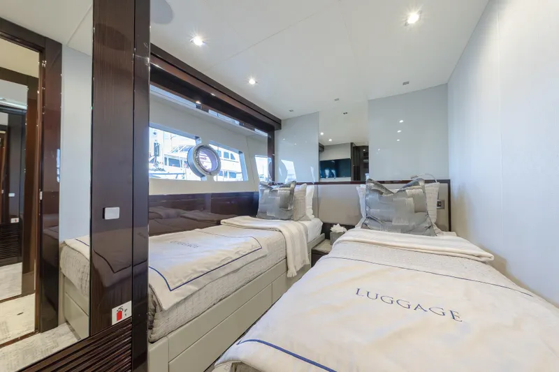 Reunion Yacht Photos Pics Luxurious twin bedroom on 2019 Sunseeker 95 Yacht, featuring elegant decor and modern amenities.