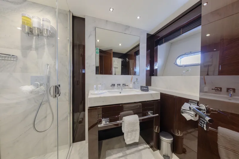 Reunion Yacht Photos Pics Luxurious bathroom on 2019 Sunseeker 95 Yacht with marble finishes and modern fixtures.