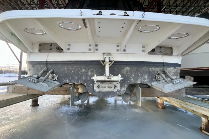  Yacht Photos Pics 1999 Sea Ray Sundancer 460 boat stern view on dry dock, showing propellers and trim tabs.