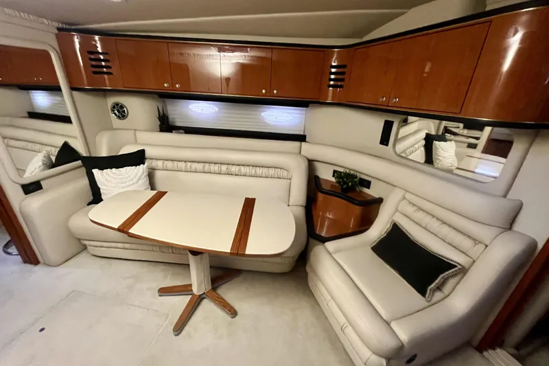  Yacht Photos Pics Luxurious interior of 1999 Sea Ray Sundancer 460 yacht with elegant seating and wooden cabinetry.