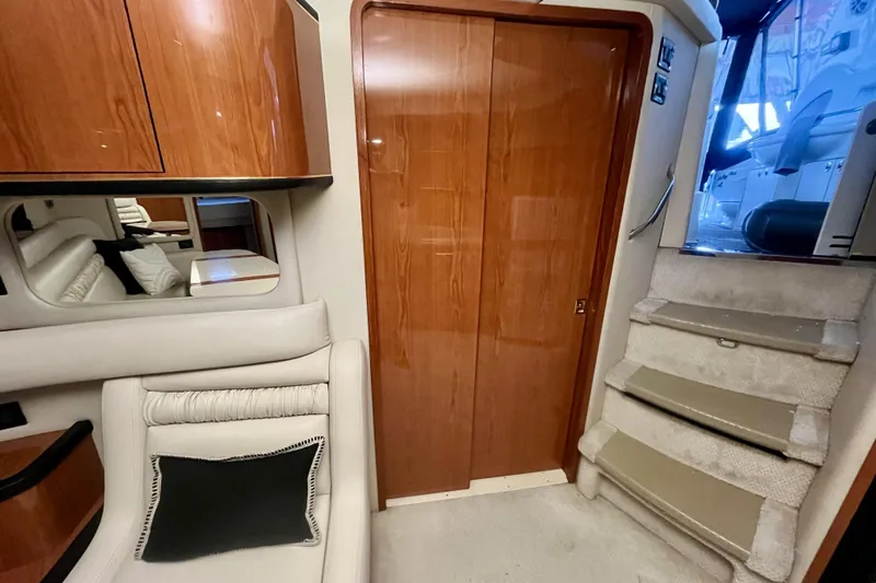  Yacht Photos Pics Interior of 1999 Sea Ray Sundancer 460 yacht with wooden cabinetry and carpeted stairs.