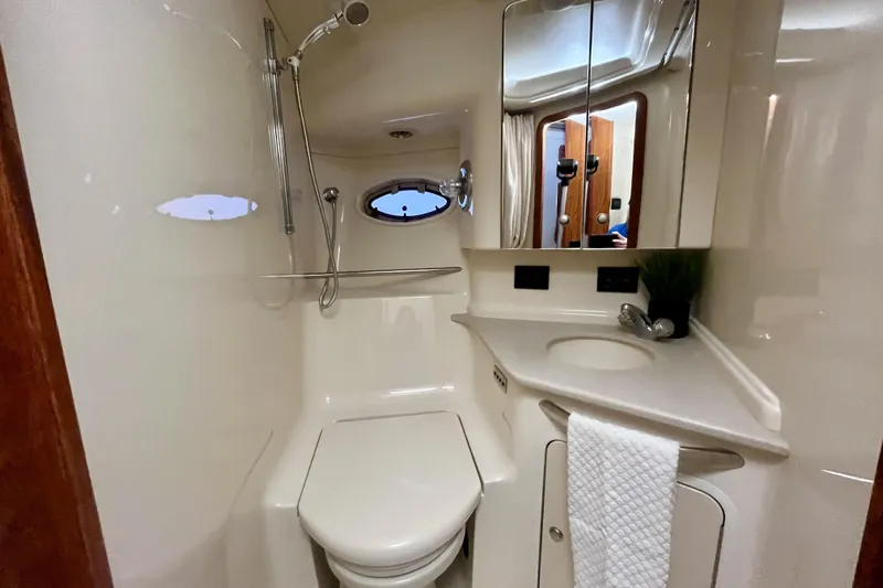  Yacht Photos Pics 1999 Sea Ray Sundancer 460 yacht bathroom with shower, sink, and mirror.