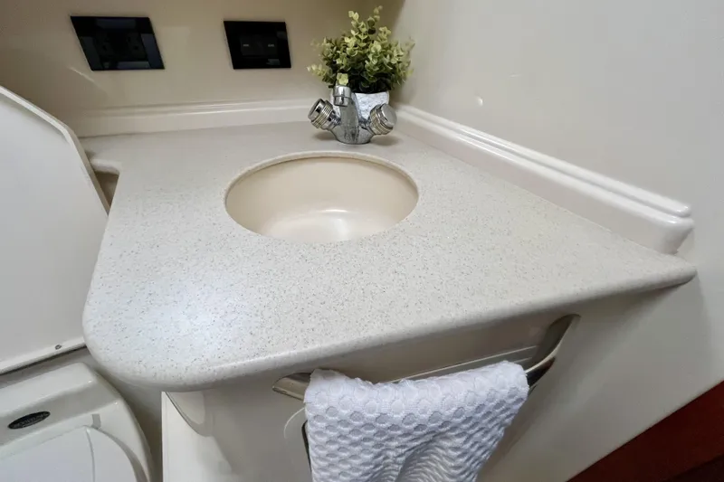  Yacht Photos Pics Bathroom sink area in 1999 Sea Ray Sundancer 460 yacht, featuring a countertop and faucet.