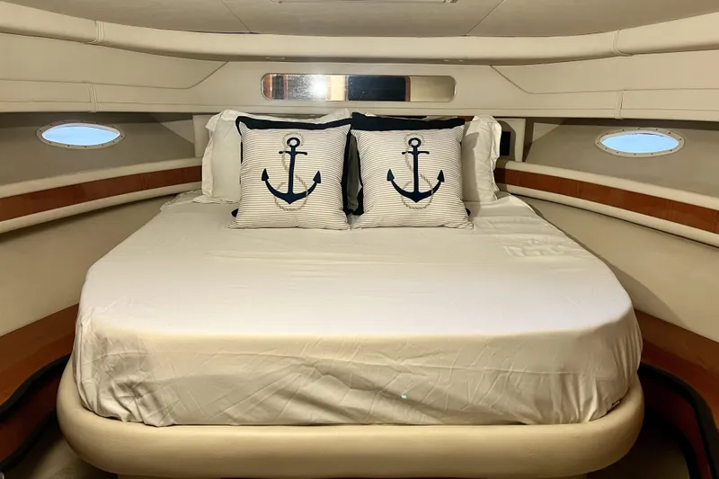 Yacht Photos Pics Luxurious cabin interior of 1999 Sea Ray Sundancer 460 yacht with nautical-themed pillows.