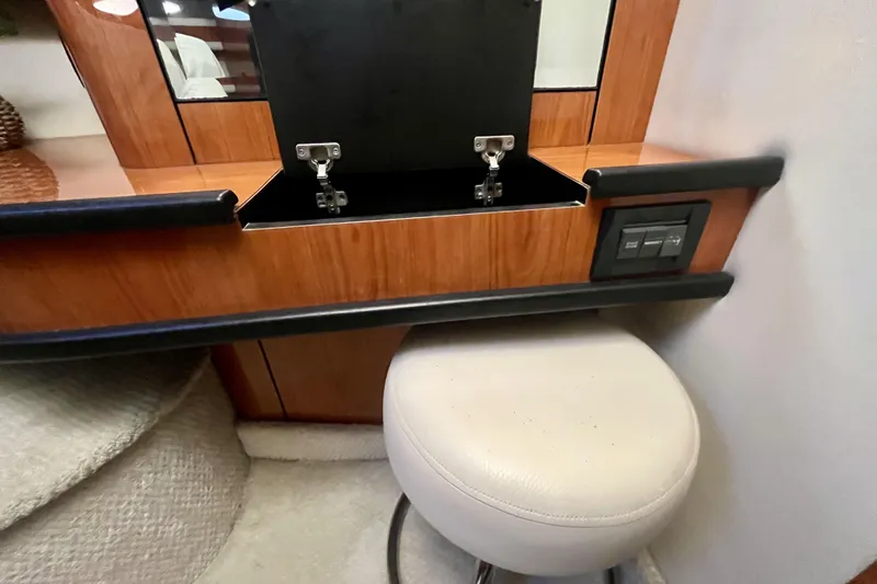  Yacht Photos Pics Interior of 1999 Sea Ray Sundancer 460 with wooden cabinetry and cushioned stool.