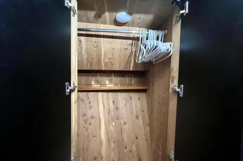  Yacht Photos Pics Wooden closet interior with hangers, Sea Ray Sundancer 460, 1999 model.