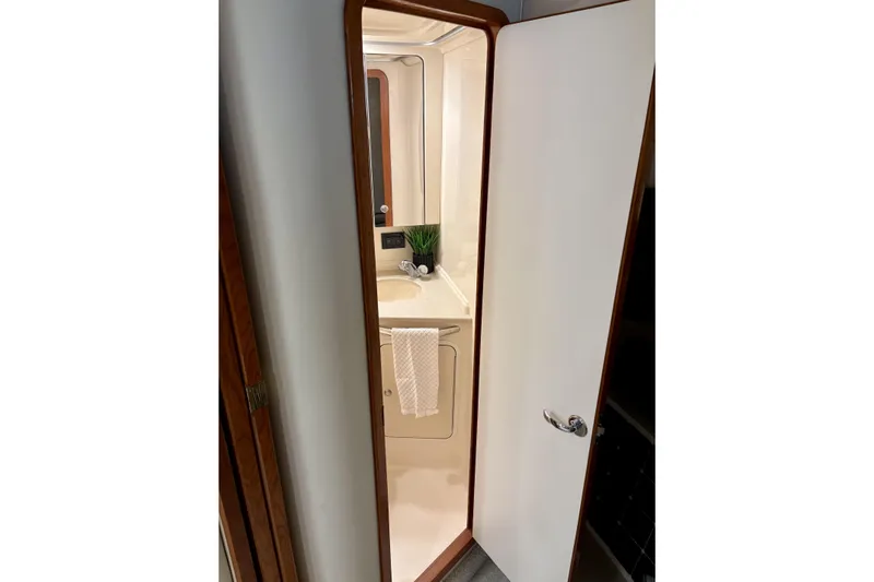  Yacht Photos Pics Bathroom interior of 1999 Sea Ray Sundancer 460 yacht, featuring sink and mirror.