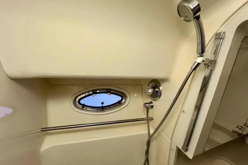  Yacht Photos Pics Shower area of 1999 Sea Ray Sundancer 460 yacht with porthole and chrome fixtures.