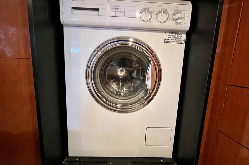  Yacht Photos Pics Washing machine inside 1999 Sea Ray Sundancer 460 yacht, wooden paneling background.