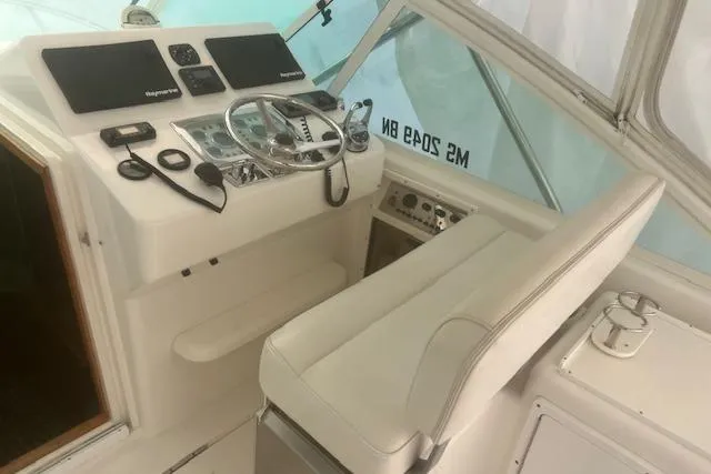 Miss Madison Yacht Photos Pics Helm of 2003 Cabo 35 Express boat with steering wheel and navigation equipment.