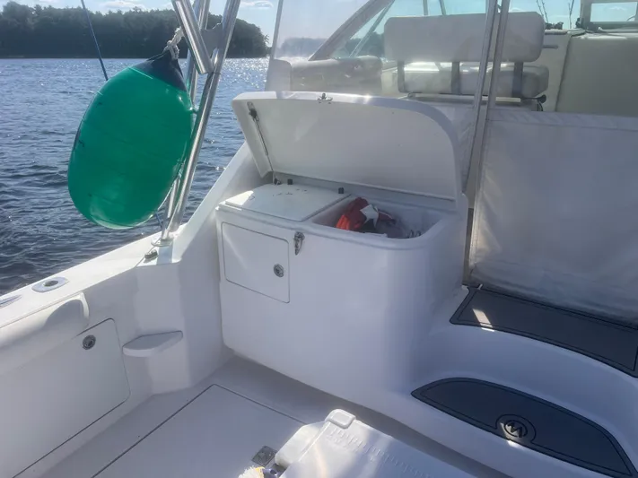Miss Madison Yacht Photos Pics 2003 Cabo Express boat interior with open storage compartment, docked on a sunny day.