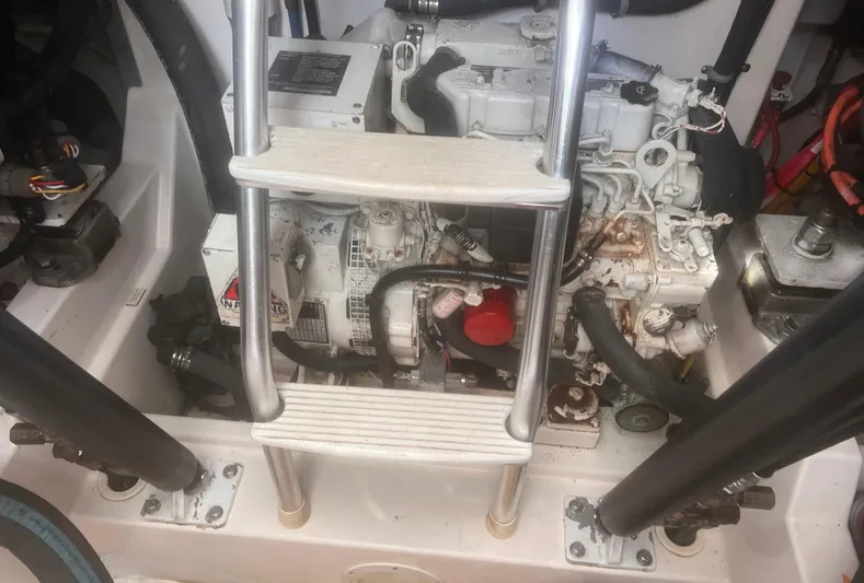 Miss Madison Yacht Photos Pics Engine compartment of a 2003 Cabo Express boat with visible ladder and components.