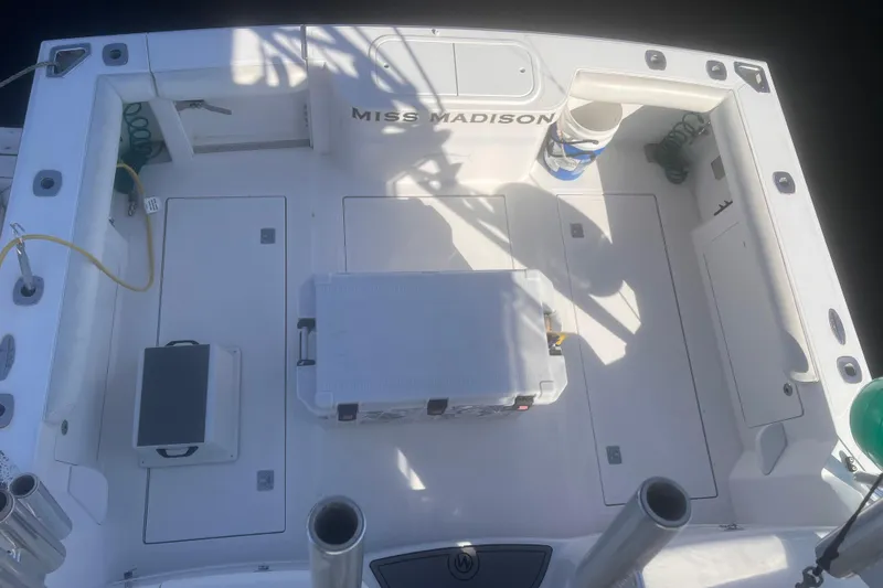 Miss Madison Yacht Photos Pics 2003 Cabo Express boat deck with storage compartments and fishing gear.